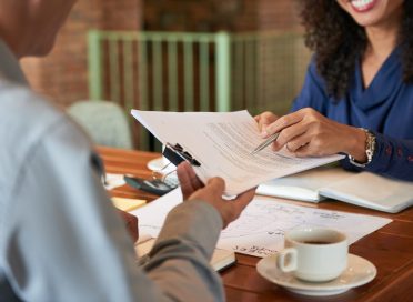 Businessman consulting with lawyer before signing contract